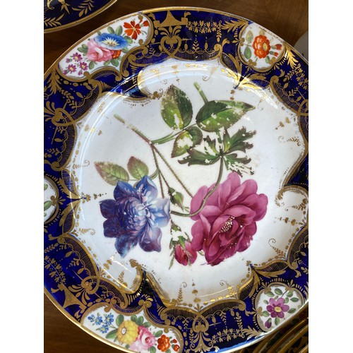 193 - A set of twelve 19th century cobalt blue and gilt dessert plates, each with central hand painted flo... 