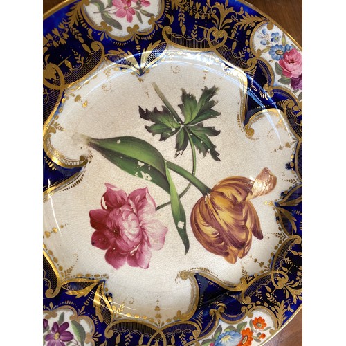 193 - A set of twelve 19th century cobalt blue and gilt dessert plates, each with central hand painted flo... 