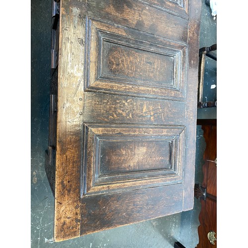 358 - A large 18th century Continental carved oak coffer, the four panel top over a profusely carved three... 