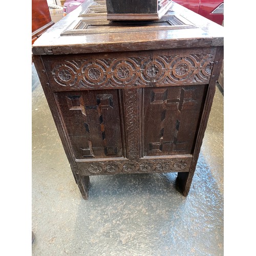 358 - A large 18th century Continental carved oak coffer, the four panel top over a profusely carved three... 