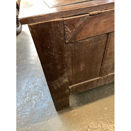 358 - A large 18th century Continental carved oak coffer, the four panel top over a profusely carved three... 