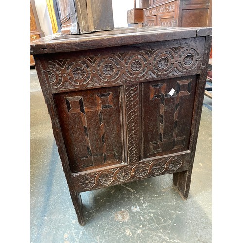 358 - A large 18th century Continental carved oak coffer, the four panel top over a profusely carved three... 