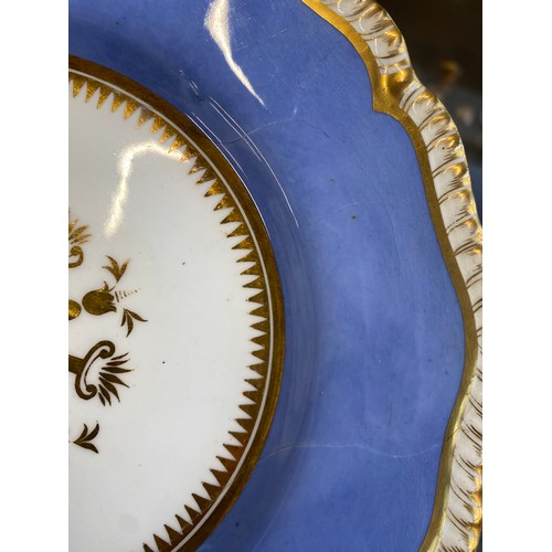 184 - A 19th century porcelain part dinner service, periwinkle blue heightened in gilt, comprising side pl... 