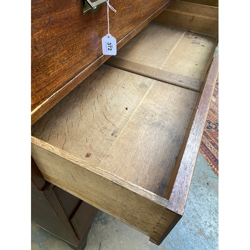 372 - A 19th century teak campaign chest, in two sections, the secretaire drawer over three further gradua... 