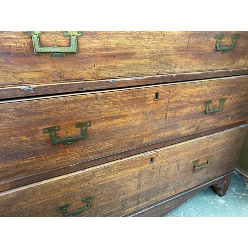 372 - A 19th century teak campaign chest, in two sections, the secretaire drawer over three further gradua... 