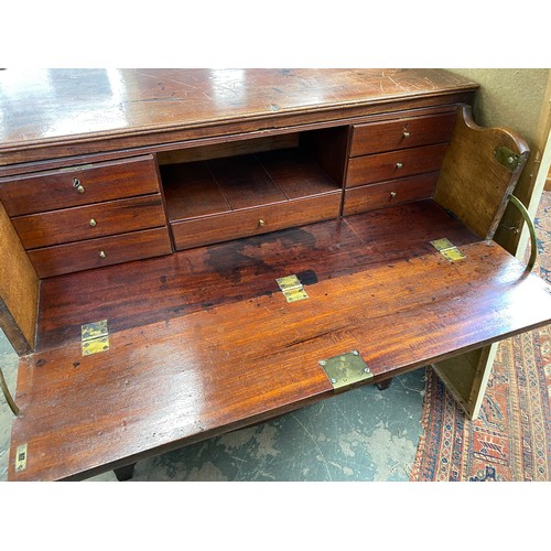 372 - A 19th century teak campaign chest, in two sections, the secretaire drawer over three further gradua... 