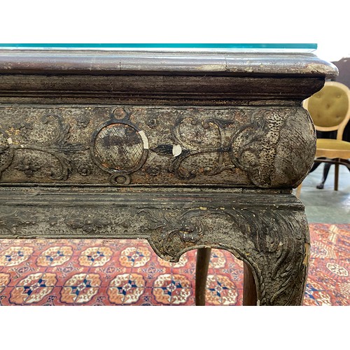 379 - An 18th century Italian gilt gesso console table, the top worked in low relief, over two slides and ... 