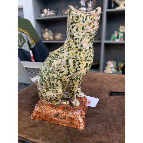 166 - A rare 19th century Scottish pearlware figure of a seated cat, sponged in Portobello type colours of... 