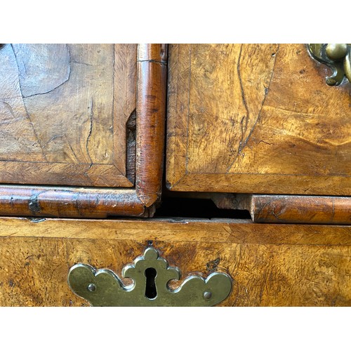 363 - An early 18th century walnut veneer cabinet on chest, the moulded cornice above a cushion frieze dra... 