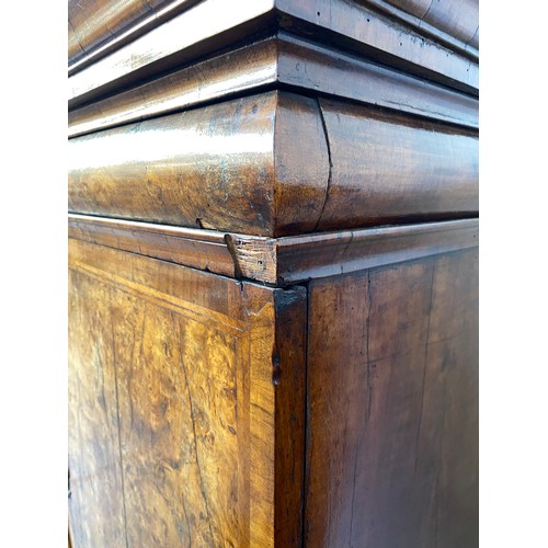 363 - An early 18th century walnut veneer cabinet on chest, the moulded cornice above a cushion frieze dra... 