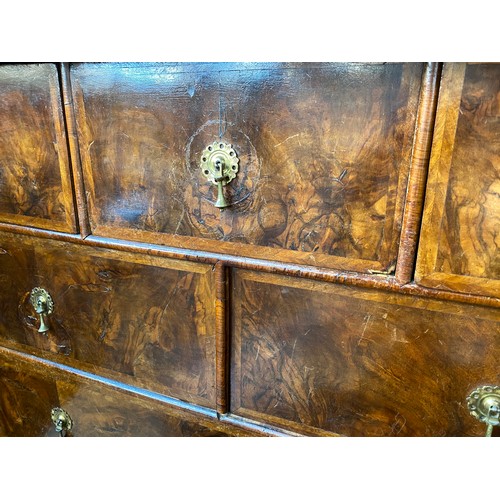 363 - An early 18th century walnut veneer cabinet on chest, the moulded cornice above a cushion frieze dra... 