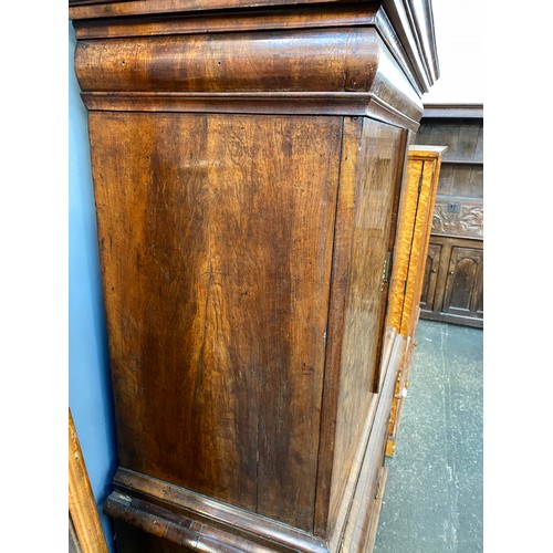 363 - An early 18th century walnut veneer cabinet on chest, the moulded cornice above a cushion frieze dra... 