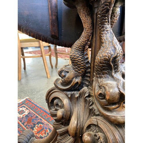 393 - An 18th century tripod table, the dished moulded top raised on a handsomely carved support formed as... 