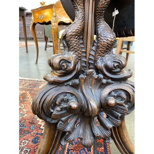 393 - An 18th century tripod table, the dished moulded top raised on a handsomely carved support formed as... 