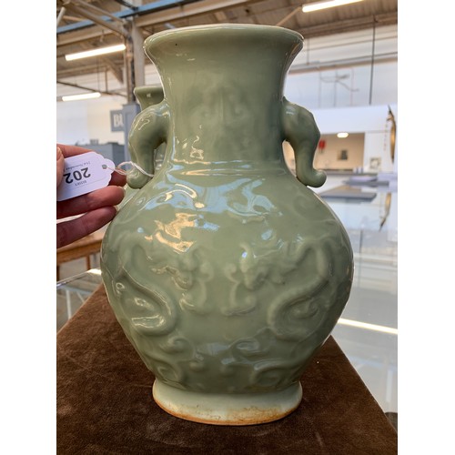 202 - A pair of Chinese Longquan celadon glaze dragon vases with twin Elephant lug handles, 27cm high, 19.... 