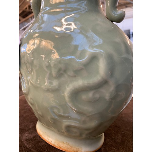 202 - A pair of Chinese Longquan celadon glaze dragon vases with twin Elephant lug handles, 27cm high, 19.... 