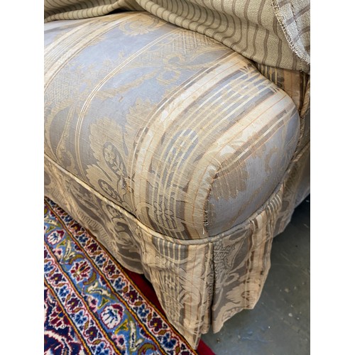 455 - A pair of Howard & Son Bridgwater armchairs, with striped loose covers, on turned front legs with st... 