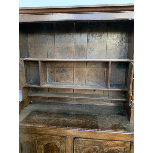 361 - An 18th century oak dresser, the rack with moulded pediment over three shelves and two cupboards, fl... 