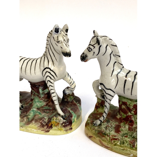 119 - A pair of Staffordshire zebra figurines, each approx 12.5cmH