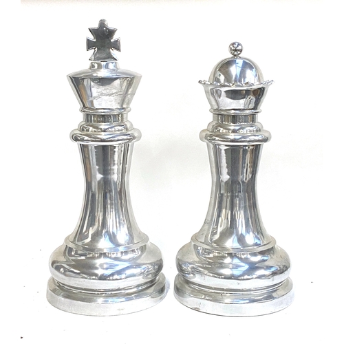 1167 - An Eichholtz oversized chromed King and Queen chess pieces, 66cmH and 61cmH