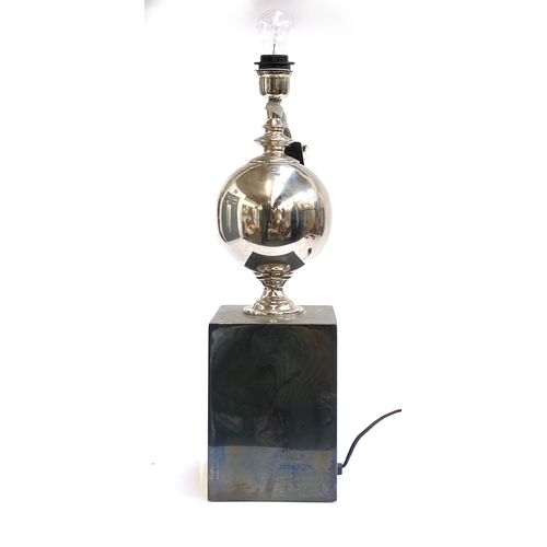 979 - An Eichholtz table lamp, chromed orb on a pattinated square base, 59cmH