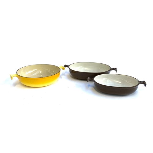 367 - Three Le Creuset dishes: a yellow twin handled dish, 23cmD, together with brown dishes, 25cmW and 21... 