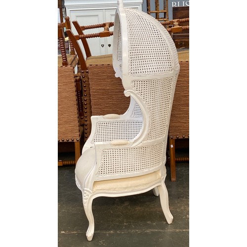 890 - A white painted double caned porters armchair, 20th century, with upholstered seats over carved cabr... 