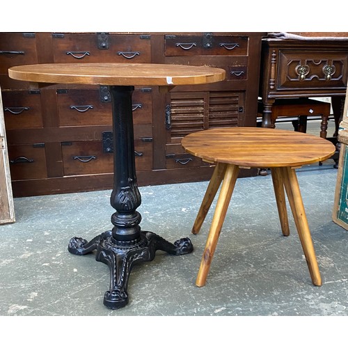 983 - A garden table with cast iron base and circular top, 69x74cmH; together with a further slatted occas... 