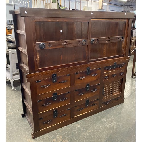 945 - A large Japanese Tansu cabinet with an arrangement of slides and drawers, 188x61x171cmH