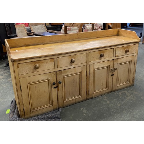 988 - A very large Victorian and later stripped pine sideboard or dresser base, three quarter gallery over... 