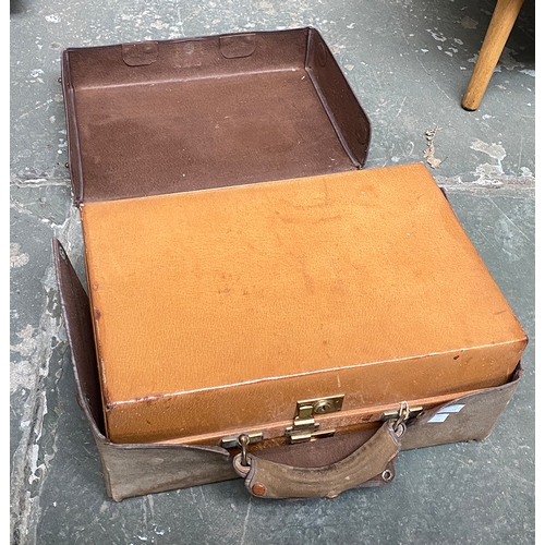 1002 - A gents pigskin overnight case with leather cover, opening in two halves to reveal to one with a fit... 