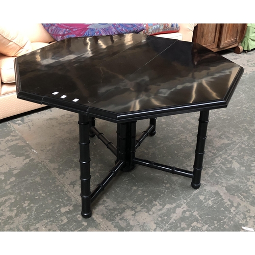 1041 - A contemporary black lacquered large octagonal Sutherland table on ring turned legs, 120cmL