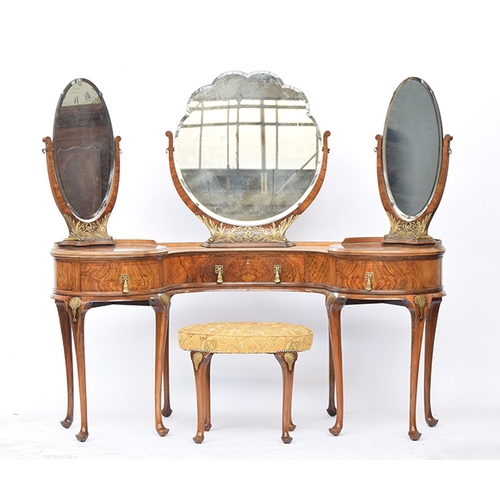 1074 - An early 20th century burr walnut veneer parcel gilt kidney shaped dressing table, with three adjust... 