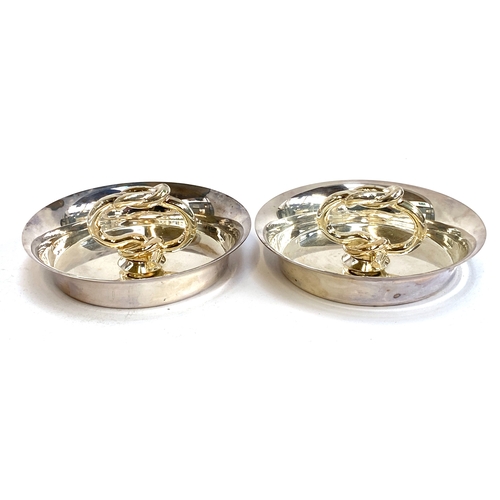 87 - Interior design interest: A smart set of four silver plated ashtrays with knot form handles, in Chri... 