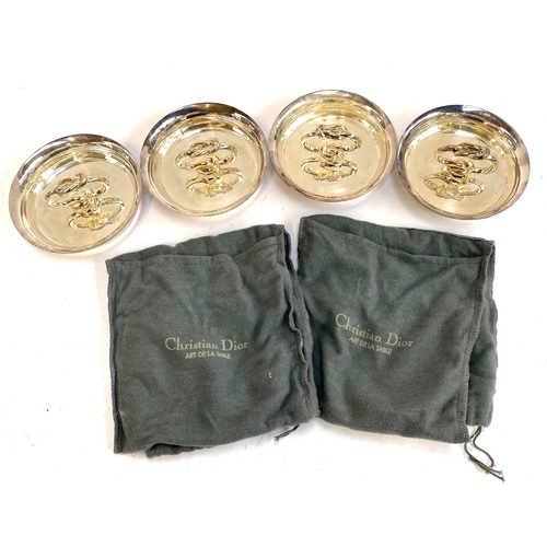 87 - Interior design interest: A smart set of four silver plated ashtrays with knot form handles, in Chri... 