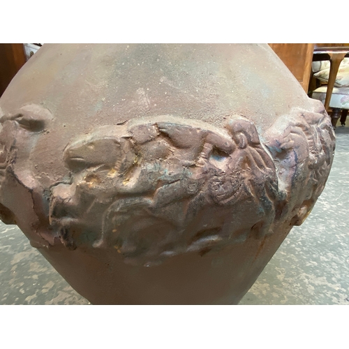 1082 - A large and heavy cast iron twin handled urn, 58cmH