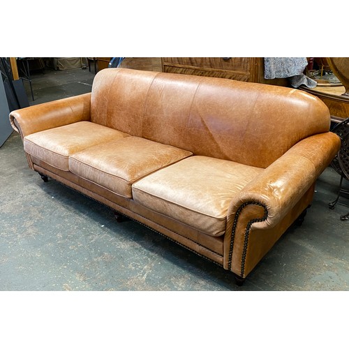 1120 - A modern three seater brown leather sofa, approx. 246cmW