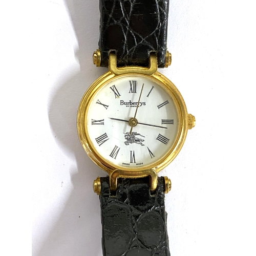 100 - A ladies Burberrys watch, with black leather strap