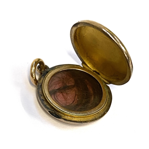 13 - An Edwardian yellow metal locket, engraved 'Margaret, Sunday July 21st 1901, 2cmD, 6.6g; together wi... 