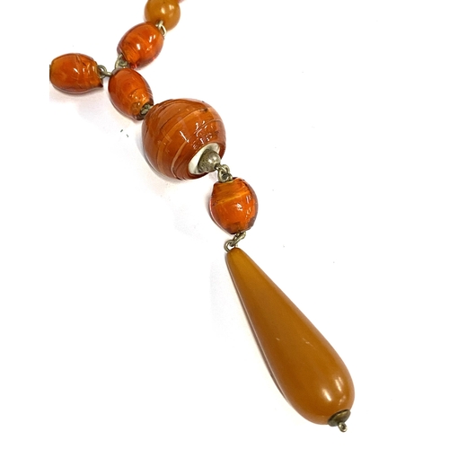 35 - A 1920s Louis Rousselet style lariat necklace comprising blown orange glass beads interspersed with ... 