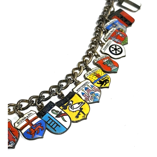 36 - An early 20th century silver charm bracelet with mainly 800 grade silver and enamel souvenir German ... 