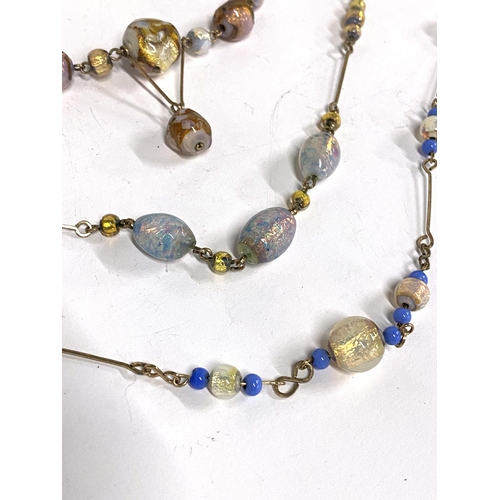 46 - Four early 20th century foiled glass bead and rolled gold wire necklaces