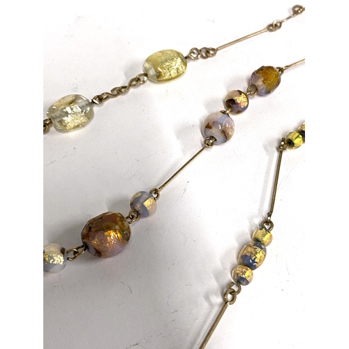 46 - Four early 20th century foiled glass bead and rolled gold wire necklaces