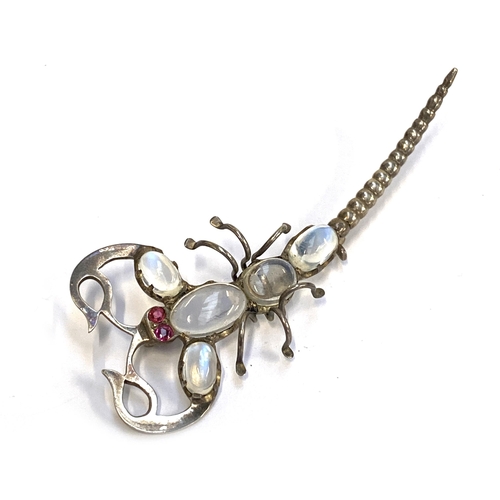 An early 20th century white metal scorpion brooch set with moonstones and ruby eyes, 7cmL, 8.6g