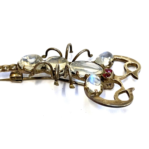 8 - An early 20th century white metal scorpion brooch set with moonstones and ruby eyes, 7cmL, 8.6g