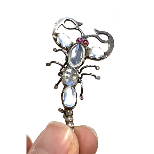 8 - An early 20th century white metal scorpion brooch set with moonstones and ruby eyes, 7cmL, 8.6g