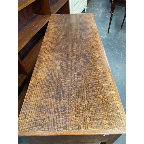 1027 - A 20th century oak dresser base, having three drawers, 125x48x85cmH