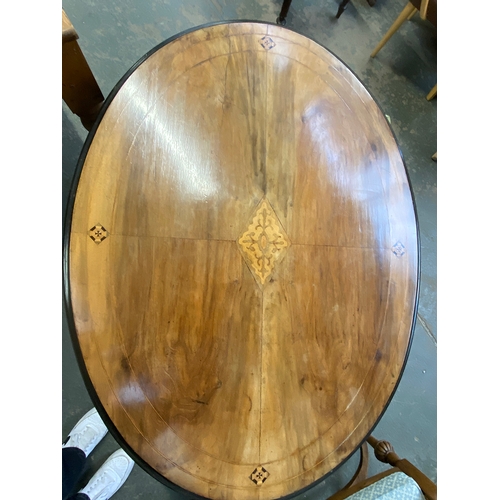 1149 - A Victorian walnut oval tilt top table, quarter veneered top with central marquetry, 115x85x69cmH