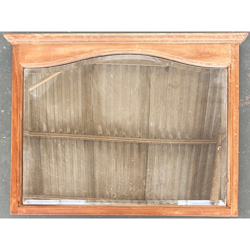 777 - A rectangular pine framed wall mirror, with shaped bevelled plate, 67x52cm