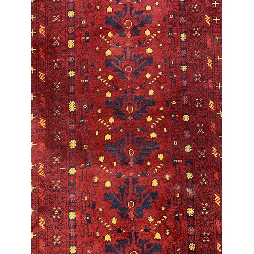 801 - A red ground runner with 14 central things and yellow bits, 92x300cm